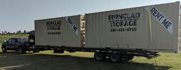 Iron Clad Storage truck hauling two storage containers Iron Clad Storage truck hauling two storage containers